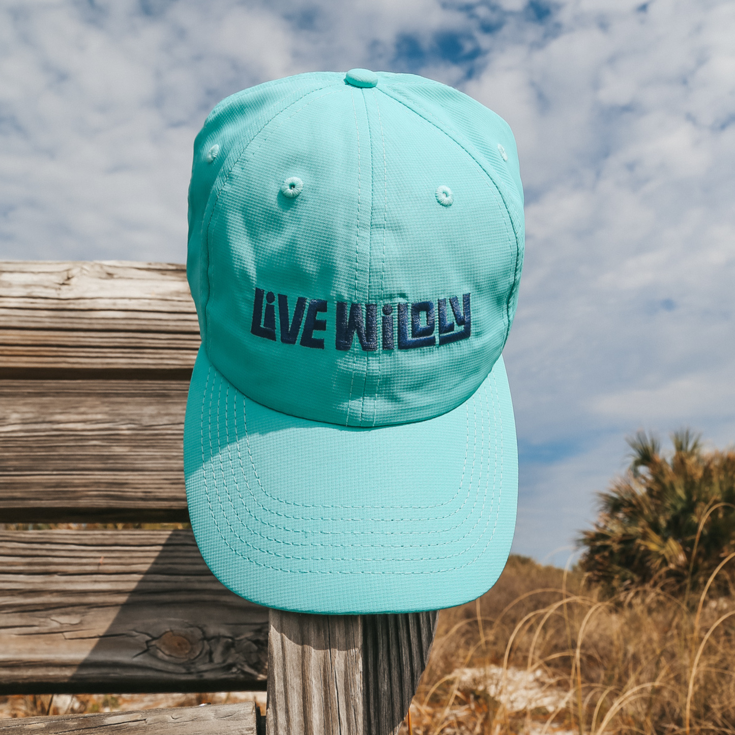 Live Wildly Performance Hats - Aqua Hanging Zoomed - Live Wildly