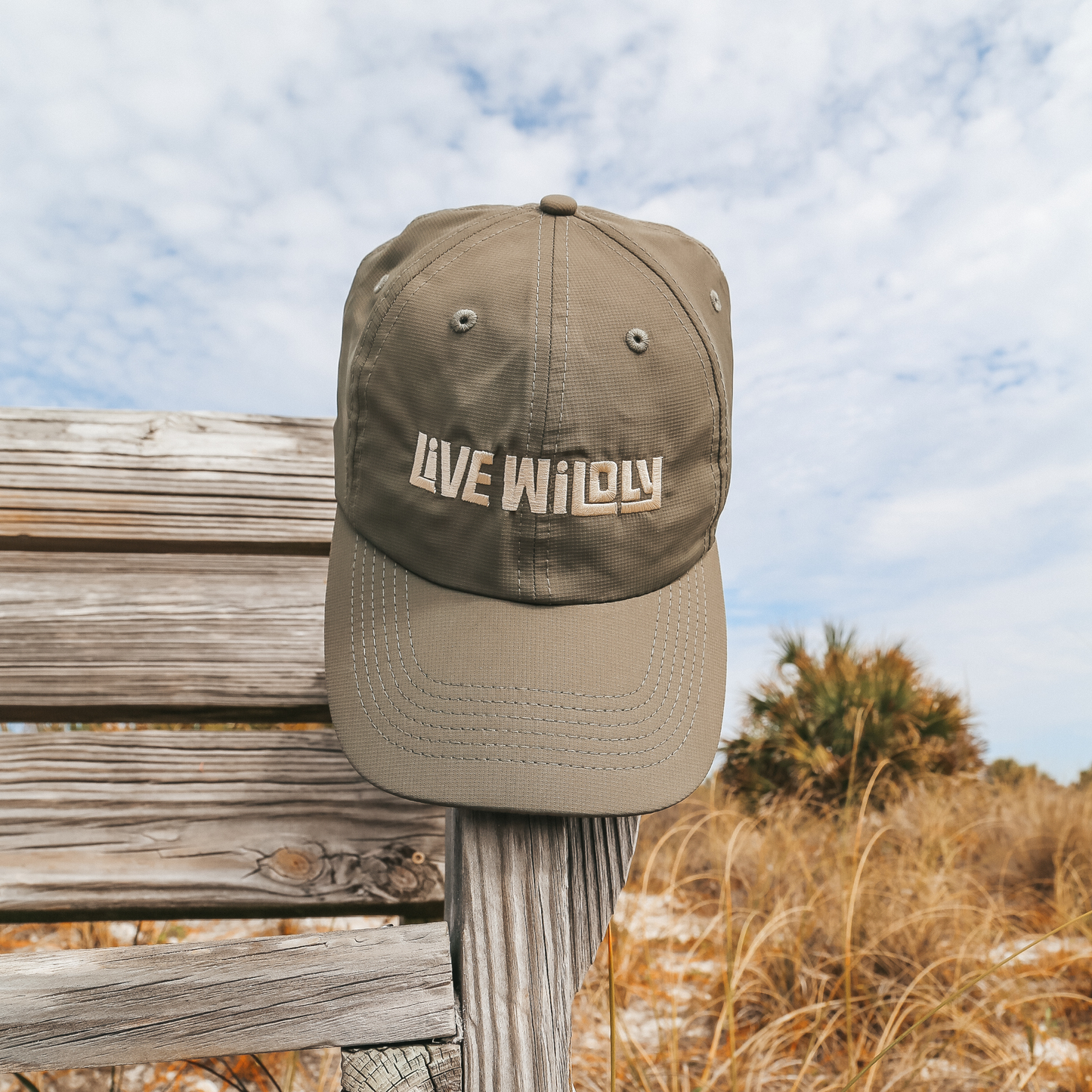 Live Wildly Performance Hats - Hanging on Bench - Live Wildly