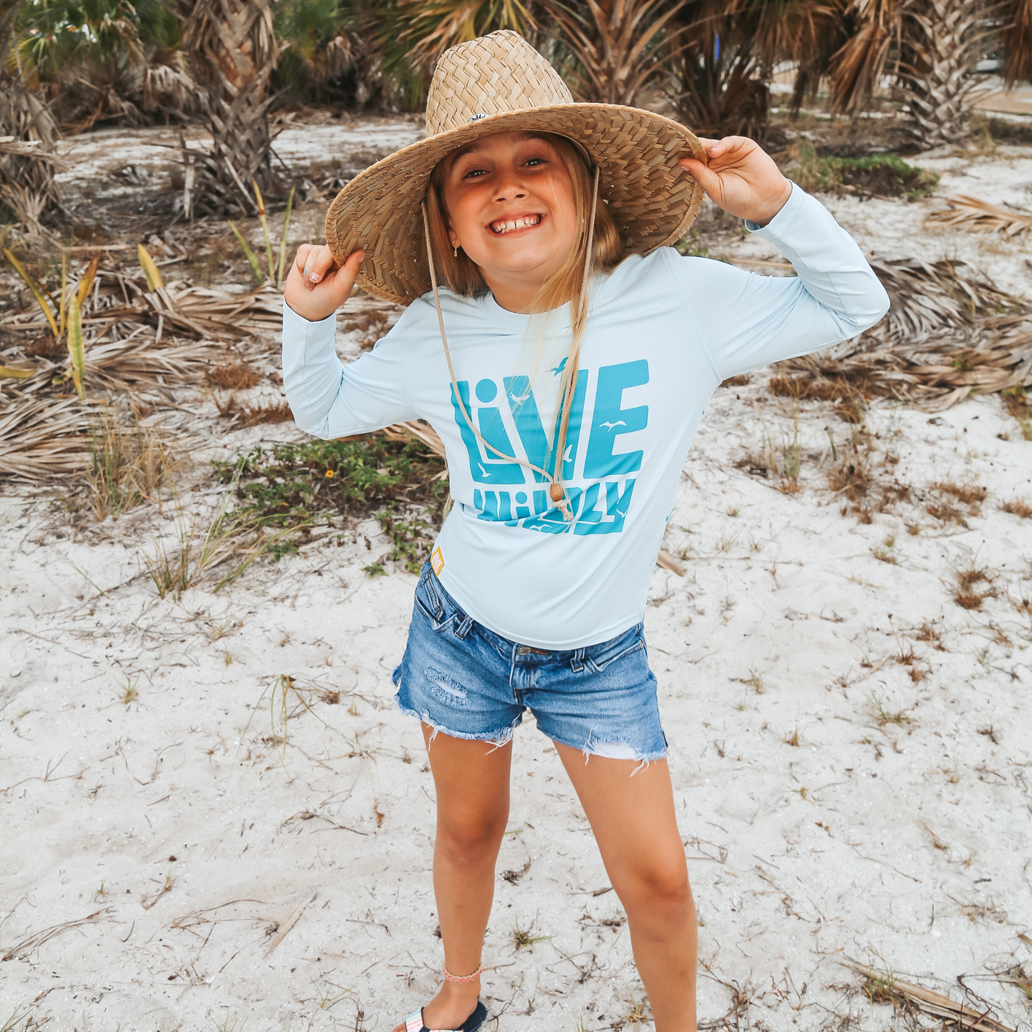 Load image into Gallery viewer, Live Wildly Youth UPF 50+ Performance Shirt - Spring Blue - Smiling Girl - Live Wildly 
