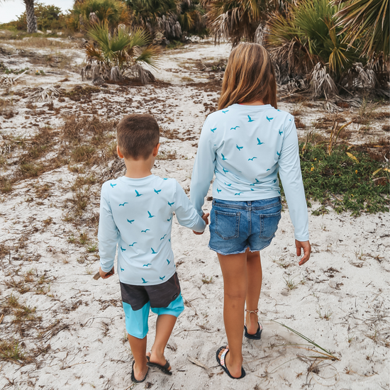 Live Wildly Toddler UPF 50+ Performance Shirt - Spring Blue On Little Travelers Holding Hands - Live Wildly 