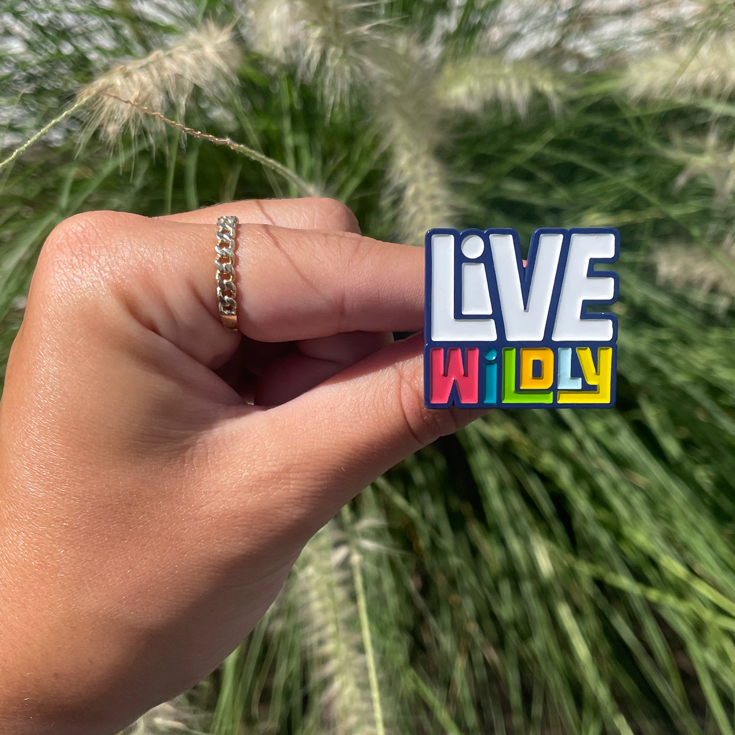 Live Wildly Enamel Pin - Held by hand - Live Wildly 